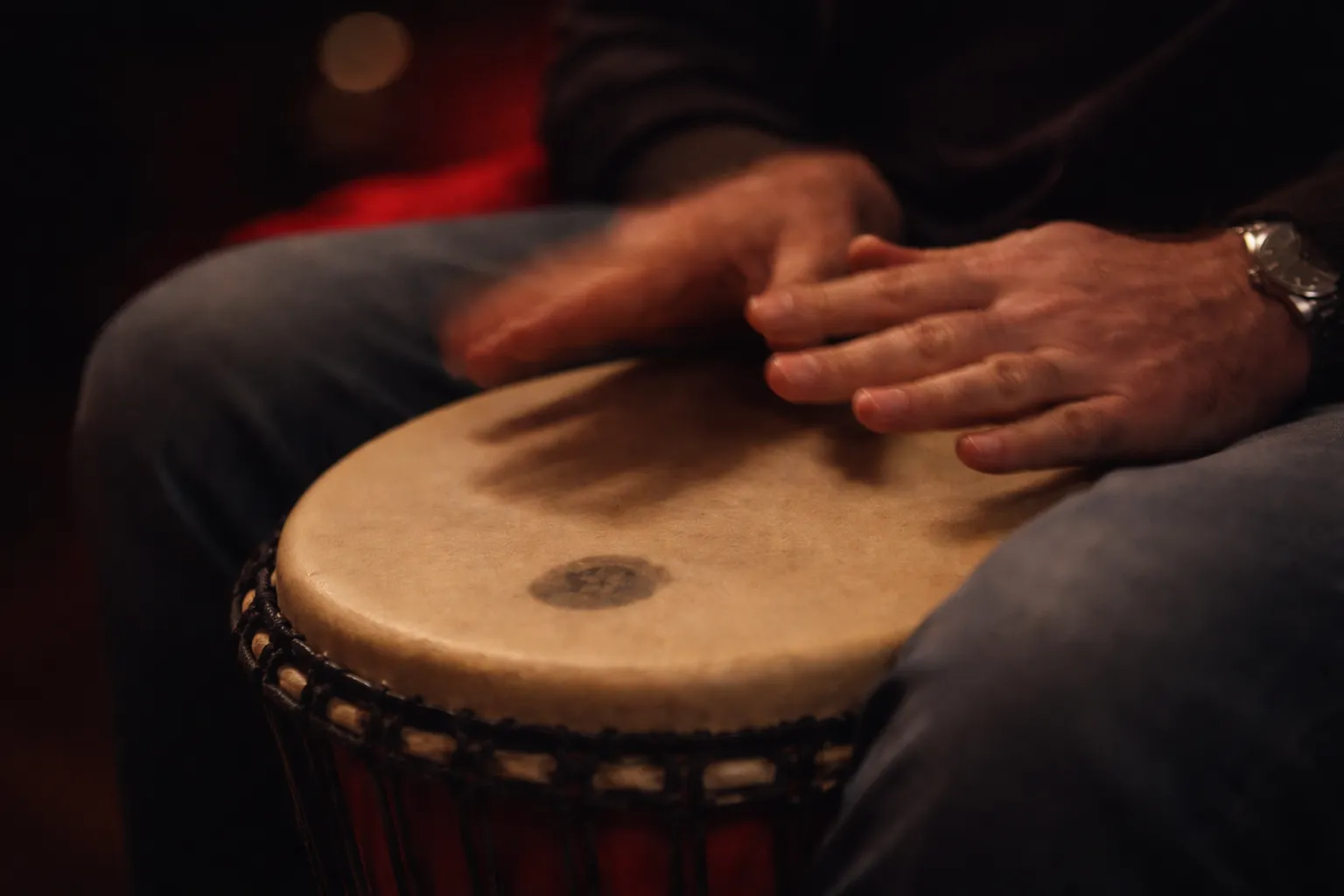 Close-up of hands on a djembe drum